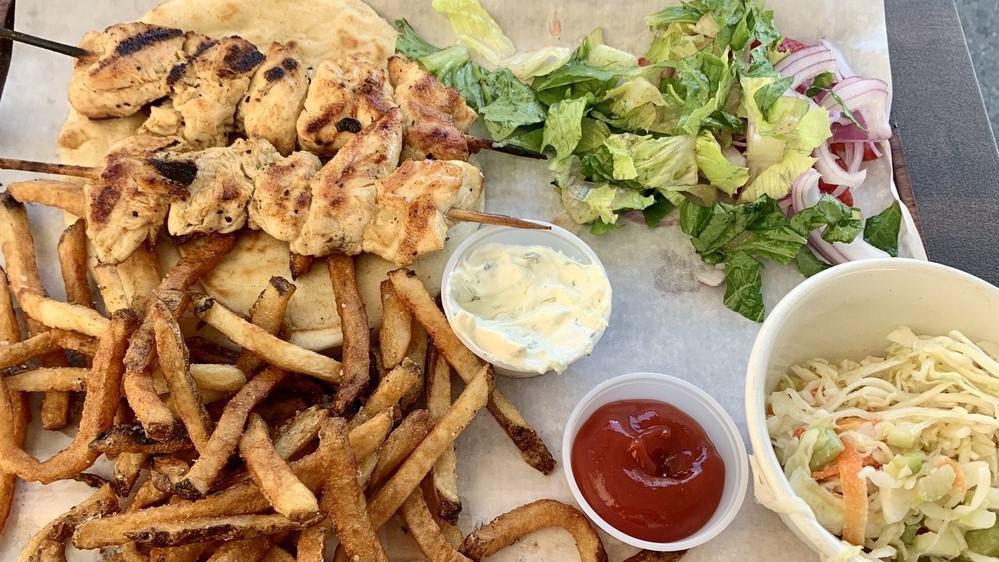 Chicken Or Pork Souvlaki · Your choice of either chicken or pork souvlaki skewers served on an open-faced pita with tomatoes, onions, & tzatziki on the side to build your perfect gyro sandwich. Served with house cut fries and Athenian slaw