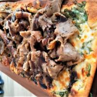 Lamb & Beef Flatbread · Tzatziki spread on a flatbread topped with spinach, Lamb & Beef Gyro meat & kefalograviera c...
