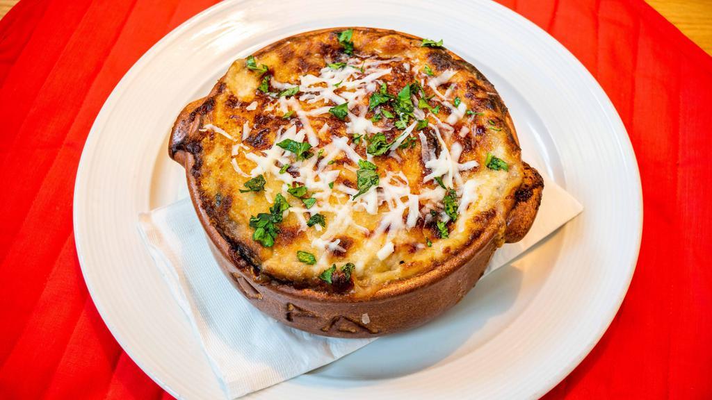 Mousaka · Greek casserole with eggplant, potatoes, ground beef tomato sauce, béchamel & kefalograviera cheese spiced with cinnamon, nutmeg & cloves.  Served with a side green salad
