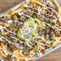Carne Asada Fries · French fries topped with steak, guacamole, sour cream, cilantro & onions, and melted cheese.
