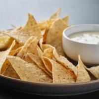 Melted Queso Dip And Chips · Melted cheddar served with a side of tortilla chips and flour tortillas or enjoy it topped w...