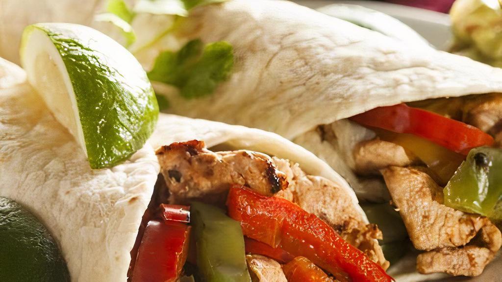 Fajita Burrito · Stuffed with your choice of steak, chicken, mixed or vegetarian style, grilled peppers and onions, cheese, rice, beans and sour cream and guac.