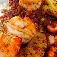 Puerto Vallarta Burrito · The magical flavors of our Surf n’ Turf burrito served wet style on a platter smothered in m...