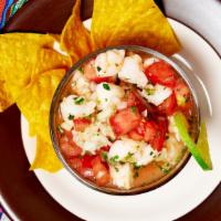 Ceviche Mexichili Style · Cooked shrimp marinated with fresh lime juice, chopped tomatoes, onions and cilantro.