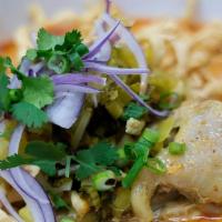 Tn16. Chaingmai Noodle Curry · Spicy. Egg noodle, pickle green mustard, shredded red onion, scallion and cilantro in Northe...