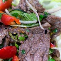 Beef Salad · Spicy. Thinly sliced broiled beef sirloin, red onion, tomatoes and cucumbers on green vegeta...