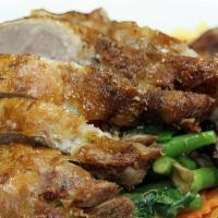 Crispy Duck Panang · Half of a boneless crispy duck with thick sweet pa nang curry with bell peppers, mushroom an...