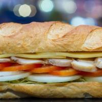 Cuban Hero Sandwich · Delicious grilled ham, Swiss cheese with pickles, lettuce, tomatoes, mustard, served on a he...