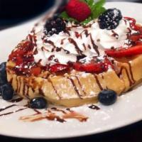 Triple Berry Waffle · One large, thick waffle with delicious homemade custard, topped with whipped cream, strawber...