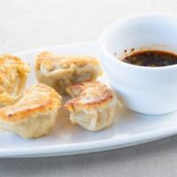 Peking Ravioli · 鍋貼 — Pork dumplings, with ginger dipping sauce. Can be made pan-fried or steamed.