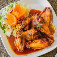 Jim'S Hot Wings · Hot and spicy. Fried chicken wings, smothered in Thai spicy sauce with shredded kaffir lime ...