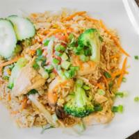 Thai Fried Rice · Shrimps, chicken, egg, broccoli, tomatoes, and carrots topped with cucumber, cilantro, and s...