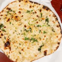 Garlic Naan · Oven cooked bread with garlic and cilantro. Finished with butter.