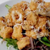 Fried Calamari · Fried calamari, pickled cucumber and pepper topped with Parmesan cheese served with sweet an...