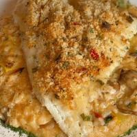 Kellys Haddock Risotto · Baked Haddock Topped with Crab Meat Stuffing. Served over Vegetable Risotto.