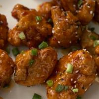 Korean Crispy Cauliflower · Deep fried cauliflower tossed in a sweet and spicy chili sauce with sesame seeds and blue ch...