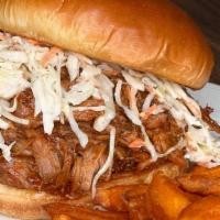 Pulled Pork Sandwich · Slow cooked BBQ pulled pork and coleslaw piled high on a brioche bun. Served with your choic...