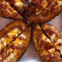 Potato Skins · Topped with melted Monterey Jack cheese and diced bacon. Sour cream and salsa served on the ...