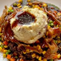 Shepherd'S Pie · Seasoned ground sirloin with corn, peas, diced carrots, caramelized onions, and whipped pota...