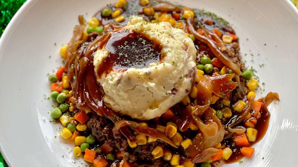 Shepherd'S Pie · Seasoned ground sirloin with corn, peas, diced carrots, caramelized onions, and whipped potatoes. Topped with demi glace.