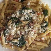 Greek Pasta · White beans, tomatoes, spinach, fresh basil and feta cheese sautéed in a white wine and garl...