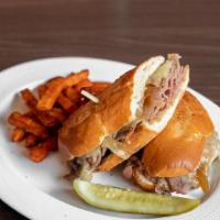 French Dip · Roast beef, Swiss cheese, and caramelized onions served on a French roll with a side of au j...
