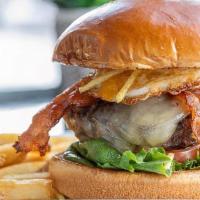 Brazilian  Burger · Burger topped with melted cheddar, bacon, fried egg, potato strings, lettuce and tomato on a...