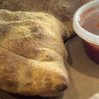 Vegetarian Delight Calzone · Fresh mushroom, onions, green peppers, fried eggplant, sliced tomatoes, and a mozzarella + p...