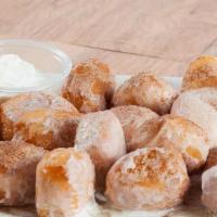 Cinna-Bites · Our dough cut into bite-sized pieces, topped with butter, sugar and cinnamon, served with ic...