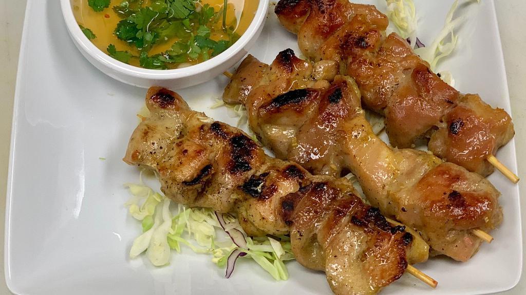 Chicken Skewers · Marniated Chicken on a stick with sweet chili sauce on the side
