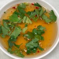 Jeow Som · Gluten free. Fish sauce, chillies, cilantro, and lime.