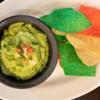 Tableside Guacamole · made in-house with fresh Hass avocados, onions, tomato, cilantro and lime juice.