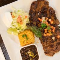 Carne Asada · grilled marinated skirt steak finished in garlic sauce, served with white rice, black beans,...