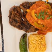 Steak Mexicano · grilled 10oz ribeye steak with salsa ranchera, Mexican rice, refried beans & jalapenos