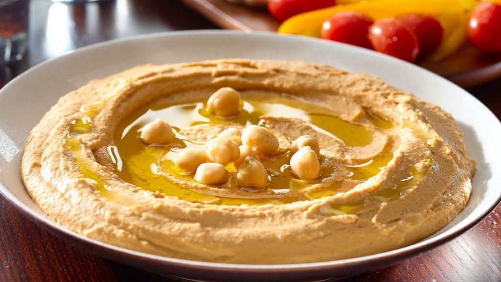 Hummus Platter · Our signature recipe of puréed chickpeas, tahini, lemon, and garlic. Served with pita, your choice of french fries, rice, or a side of hummus salad, and two additional sides.