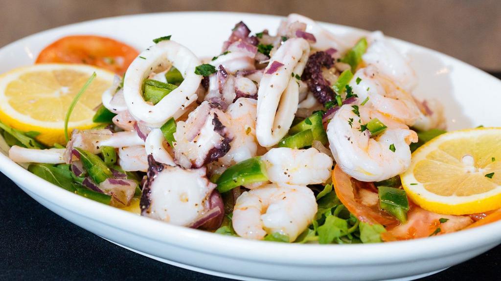 Marinated Seafood Salad · Marinated octopus, calamari, baby shrimp, red onions, celery and green peppers in a lemon olive oil dressing.