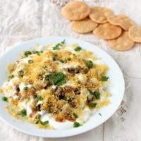 Aloo Papdi Chaat · Flour crisps topped with potatoes, chickpeas, yogurt, mint & tamarind sauce.