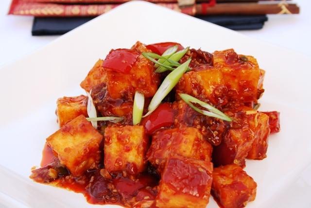 Chilli Paneer · Cubes of homemade cottage cheese served with green peppers & onions sautéed in schezwan sauce.