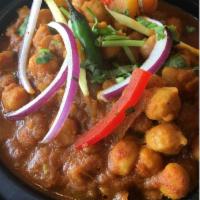 Channa Masala · Chick peas cooked with ginger, garlic, onions & tomatoes finished with freshly ground Indian...