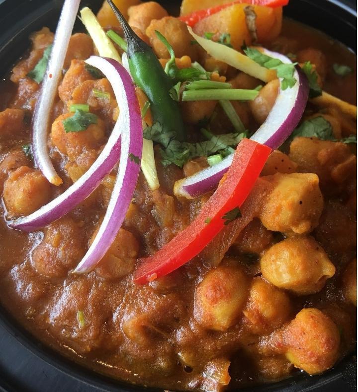 Channa Masala · Chick peas cooked with ginger, garlic, onions & tomatoes finished with freshly ground Indian spices.