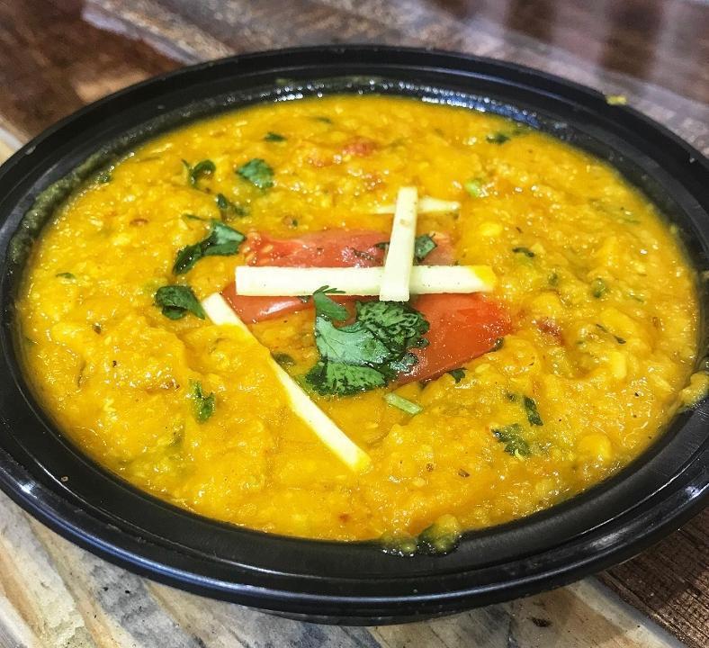 Tadka Dal · Lentils smoothly blended with tomatoes, onions & traditional Indian spices.