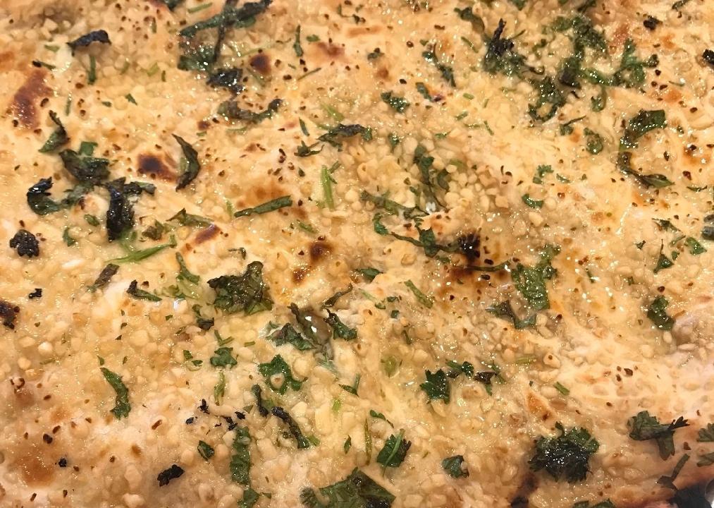 Garlic Naan · White flour naan with minced garlic garnished with cilantro.