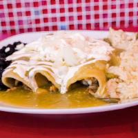 Green Enchiladas · Corn tortillas with chicken smothered in a green tomatillo sauce and topped with fresh Mexic...