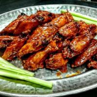Wings · Cooked wing of a chicken coated in sauce or seasoning.
