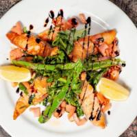 Insalata Salmone · Grilled wild salmon, arugula, grilled asparagus, chopped tomatoes, balsamic and olive oil.