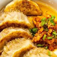 Mandu · pork and kimchi dumplings, served with a sweet soy dipping sauce