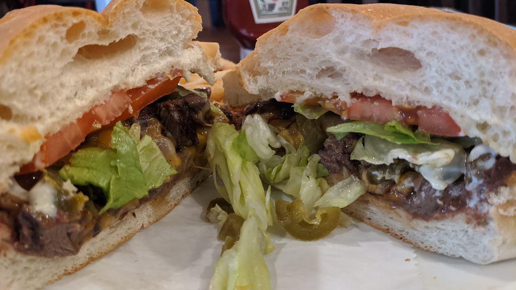 Steak Torta · A traditional Mexican sandwich made with fresh bread, lettuce, avocado, beans, mayonnaise, jalapenos, tomatoes, and Monterrey Jack cheese. Served with side of fries.
