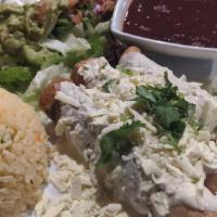 Flautas · Lightly crisped rolled corn tacos filled with pulled chicken and topped with cotija cheese, ...