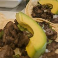 Steak Taco · Served in a corn tortilla with lime cilantro, onions, and a homemade hot sauce.