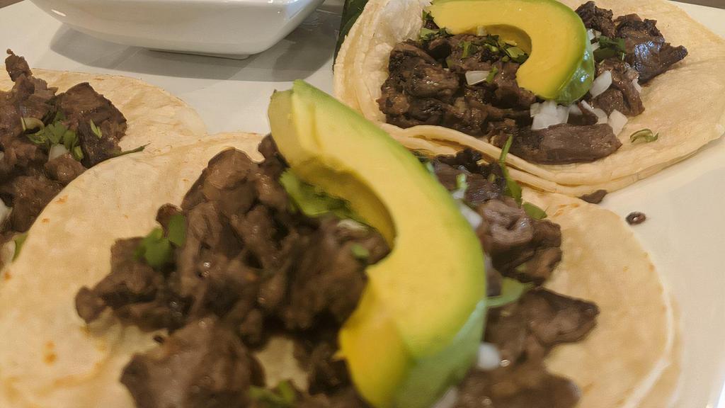 Steak Taco · Served in a corn tortilla with lime cilantro, onions, and a homemade hot sauce.